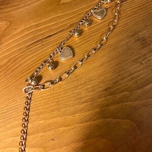 Gold tone bracelet double strung with chain links, heart, bead on chain 5 1/2-8”